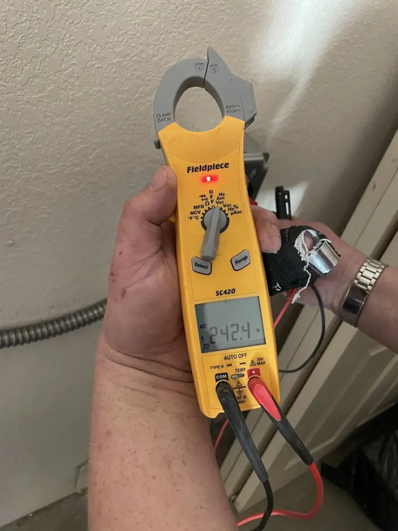 Voltage testing with clamp meter during Whole House Surge Protector in Pecan Grove